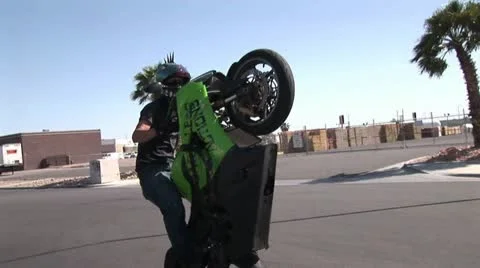 Rider With Mohawk Helmet Dances On A Moving High Performance Motorcycle 動画素材 18971032