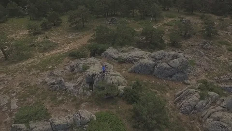 Rider with is mountain bike while drone goes around Stock Footage 75885767