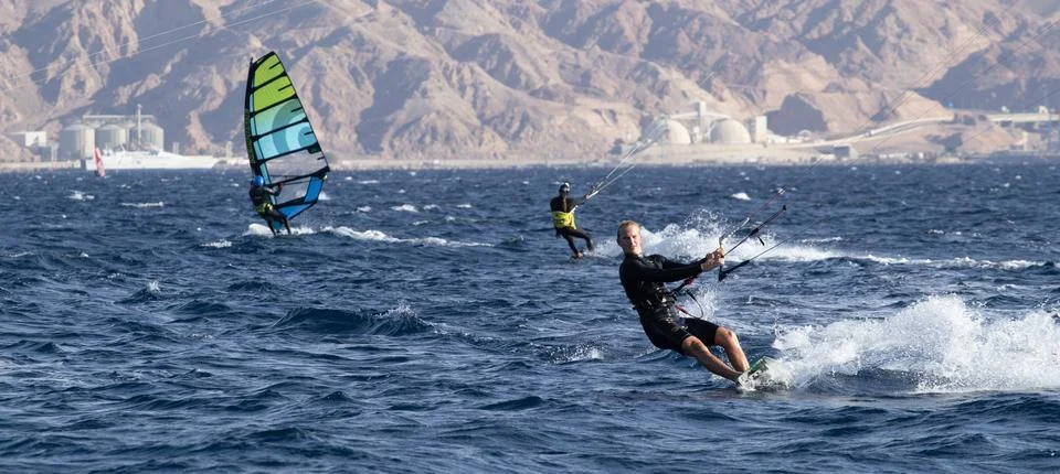 Rider rides a board under a kite Stock Photos