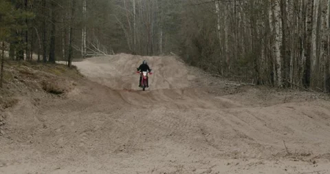Rider skillfully navigating an OffRoad Motorcycle while exploring a scenic Stock Footage 310513014