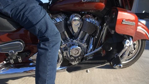 A rider starting out on a classic style motorcycle Stock Footage 88453133