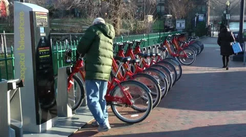 Rider unlocks bike - Capital BikeShare, Washington, DC Stock Footage
