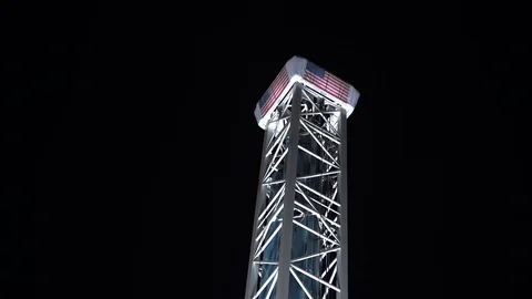 Riders go shooting up a space styled thrill ride at Santa Cruz Beach Stock Footage 95654414
