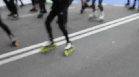 Riders on roller skates and Handicapped wheel chair hand-bikers in marathon Stock Footage 56575796