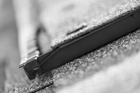 Ridge cap vent installed on a shingle roof for passive attic ventilation on a Stock Photos