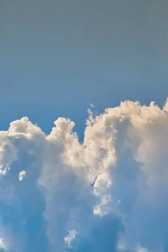 Ridge of clouds in blue sky close-up, clouds cluster in the sky, cyclone form Stock Photos