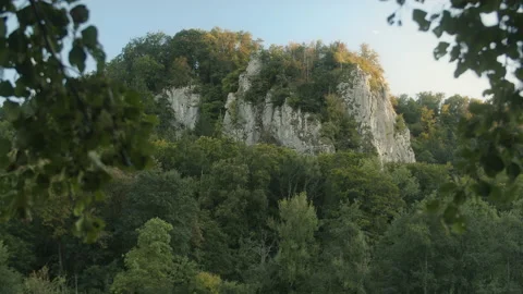 A ridge with many trees and a big rock in the evening. Stock Footage 167353138