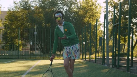 Ridiculous freak man throws and catches tennis ball Video stock 133961247