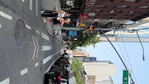 Riding along bicycle line in Hell's Kitchen neighborhood. Restaurants along road Stockbeeldmateriaal 242703497