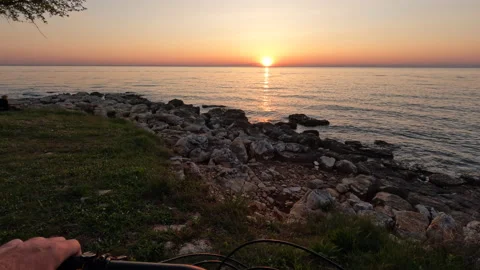 Riding bicycle point of view and watching the mediterranean sea sunset Stock Footage 188938729