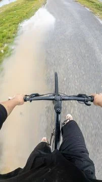 Riding Bicycle Through Puddle Fotos de archivo