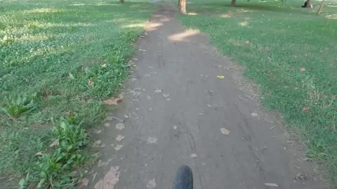 Riding a bike down the muddy path through the city park Stock Footage 280971198