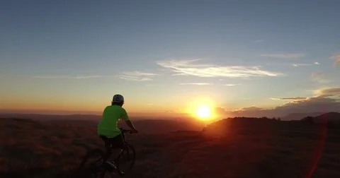 Riding bike at sunset Stock Footage 82354733
