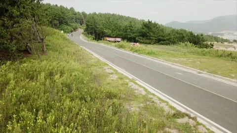 Riding bikes along the east cost of Korea Stock Footage