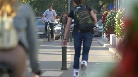 Riding bikes and roller skating on a street in Bucharest Stock Footage 57970525