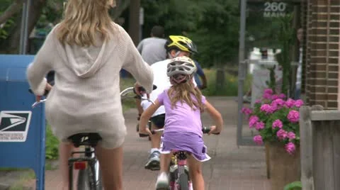 Riding bikes through town (3 of 7) Video stock 16707331