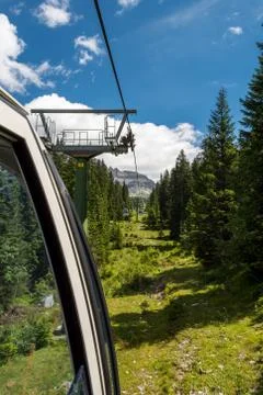 Riding a cable car through a forest. Stock Photos