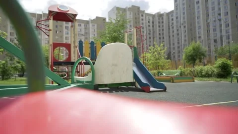Riding on a carousel in the closed playground view from the seat Stock-Footage 131728801
