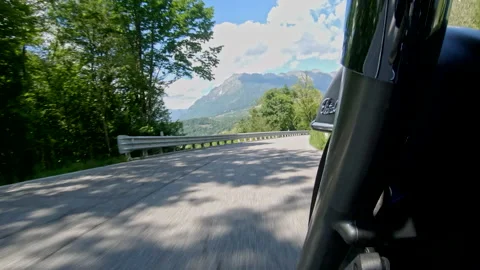 Riding down the hill on a chopper on a mountain road low angle pov Stock Footage 135011260