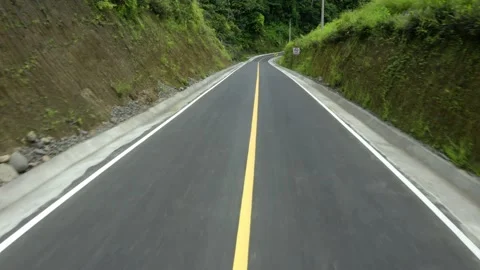 Riding down a mountain road going down a hill in the forest Video stock 165845985