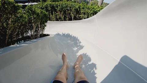 Riding down slide at waterpark Stock Footage 106795490