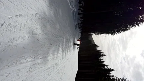 Riding down by snowed slope at ski resort winter vacation Stock Footage 165994944