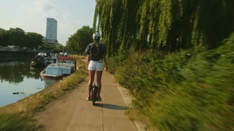 Riding EUC at Three Mills Green in London in Summer Stock Footage 195083352