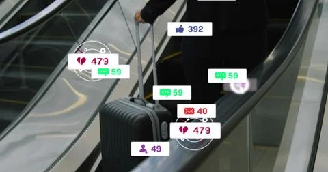 Riding executive in dark suit pulling suitcase on escalator with social icons, Stock Photos