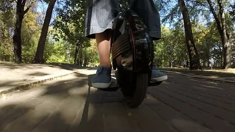  Riding mono wheel, personal electrical city transport in city park Stock Footage 80163644