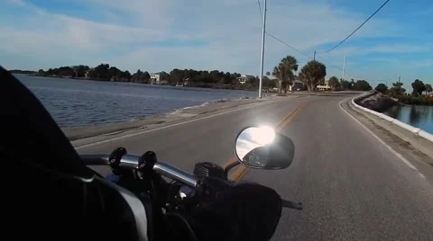 Riding on motorcycle across bridge Vídeos de archivo 47334546