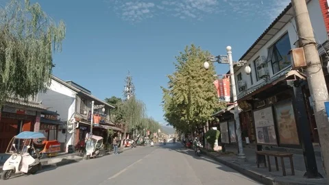 Riding Motorcycle along a Commercial Street at Dali, Ancient Chinese Town. Stock Footage