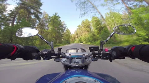 Riding a motorcycle on forest road Stock Footage 46703374