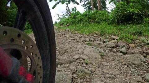Riding a motorcycle on a mountain road view from the wheel 库存影片 243217253