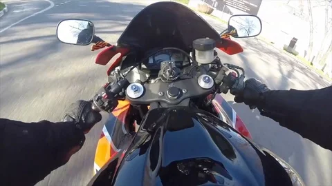 Riding a motorcycle through the city, the driver closes the helmet Stock Footage 104752952