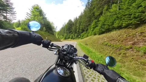 riding motorcycle through the green fields in sunny summer on curvy road Stock Footage 313805228