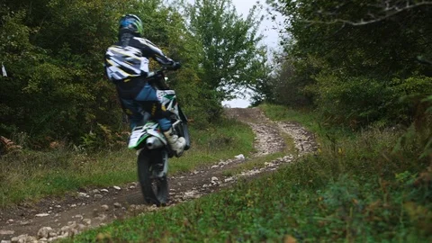 Riding on motorcycle through the rocks on the rear wheel 4k Stock-Footage 89596109
