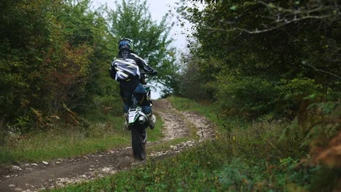 Riding on motorcycle through the rocks on the rear wheel 4k Stock-Footage 89596174