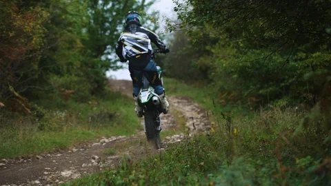 Riding on motorcycle through the rocks on the rear wheel 4k Stock-Footage 89596381