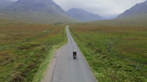 Riding motorcycle in a valley Stock Footage