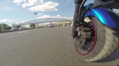 Riding a motorcycle, view on front wheel Stock Footage 46703199