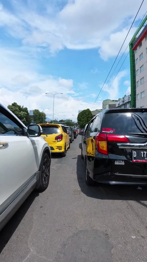 Riding a motorcycle, weaving through the queue of cars Stock Footage 329394409