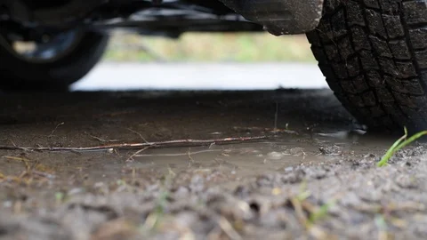 Riding on a muddy road in the rain, the result is a muddy car, mud flaps, wheels Stock Footage 89254458