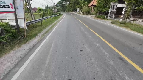 Riding pov passing through the small town in Central Java, Indonesia Stock Footage 316877313
