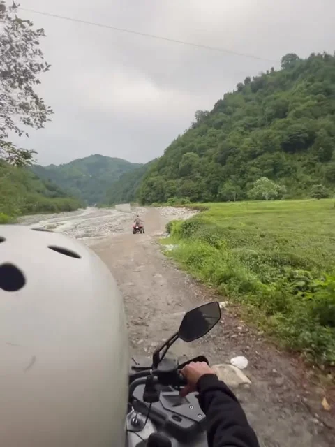 Riding Quad Bikes on Off-Road Dirt Trail Along Mountain River Stock Footage 339880533