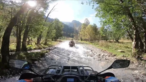 Riding a quad on a mountain river, first-person 2 Stock Footage 98084499
