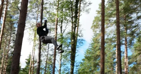 Riding on a rope stretched between the trees, Climbing park "Nut" Stock Footage 88995928