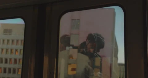 Riding on a Train Looking out of the Window Passing by Buildings and Trees Stock Footage 160537839