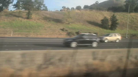 Riding a train next to a freeway Stock Footage 555176