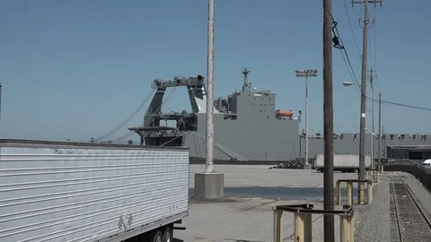 Riding the Train towards large, grey ship with tracks in front Stock Footage 123507134