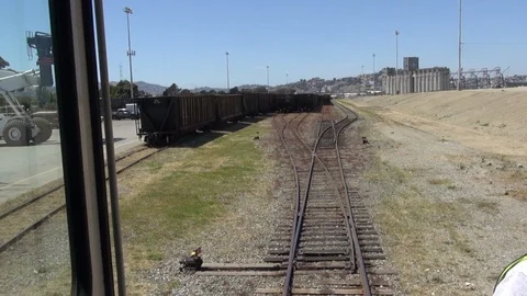 Riding the train, tracks appear with partail shot of foreman Stock Footage 123505443